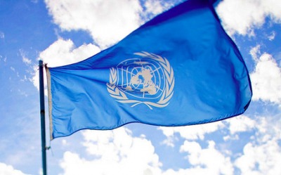 Flag of the United Nations in the blue sky.