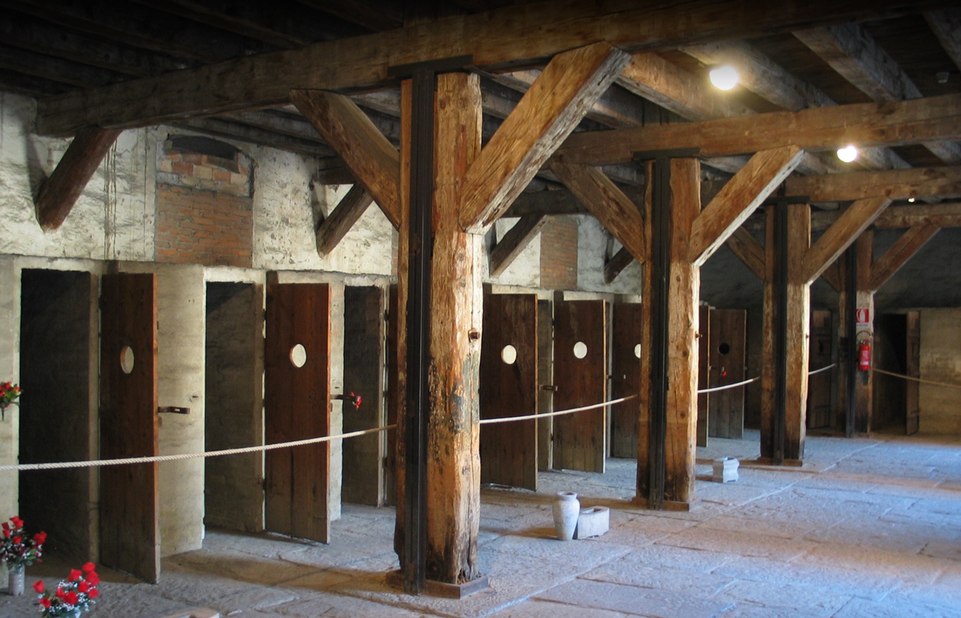 Trieste's Rice Mill, turned into a prison camp during WWII. This photo depicts the doors of the cells. There are red flowers to remember all victims.