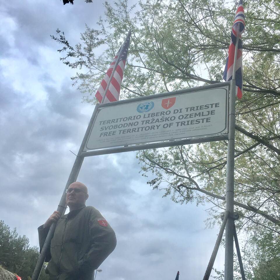 Roberto Giurastante at one of Free Trieste's sit-ins on the border of Trieste with Italy. The British and US flags represent Trieste's primary adminsitering Governments (July 2019).